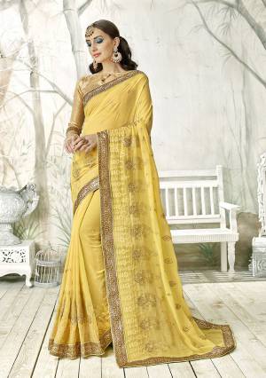 Rich And Elegant Looking Designer Saree Is Here In Yellow Color Paired With Golden Colored Blouse. This Saree Is Fabricated On Georgette Paired With Art Silk Fabricated Blouse. Both Its Fabrics Are Light Weight And Easy To Carry All Day Long. 