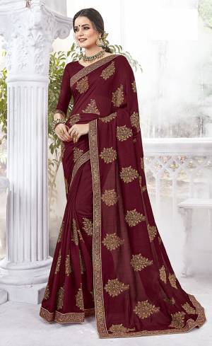 Rich And Elegant Looking Designer Saree Is Here In Maroon Color Paired With Maroon Colored Blouse. This Saree And Blouse are Silk fabricated Beautified With Thread Embroidery And stone Work .It Is Light Weight And Easy To carry All Day Long. 