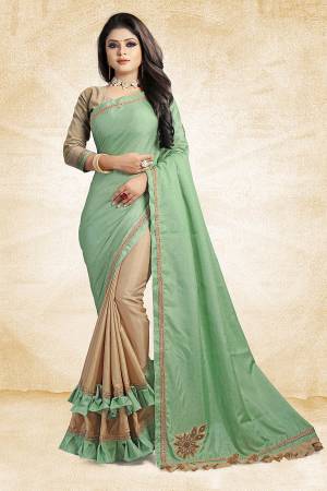 For A Rich And Elegant Look, Grab This Designer Saree In Light Green And Beige Color Paired With Beige Colored Blouse. This Saree And Blouse Are Silk Based Beautified with Embroidered Patch Work And Lace Border. Buy Now.