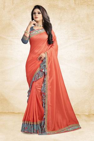 Look Pretty Wearing This Designer Silk Based Saree In Orange Color Paired With Grey Colored Blouse. This Saree And Blouse Are Silk Based Beautified With Lace Border And Printed Frill Over The Border. Buy This Pretty Saree Now.