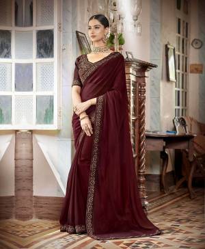Celebrate This Festive Season With Beauty And Comfort Wearing This Designer Saree In Maroon Color Paired With Maroon Colored Blouse. This Saree Is Fabricated On Satin Chiffon Paired With Art Silk Fabricated Blouse. It Is Beautified With Coding And Thread Embroidery In Tone To Tone Shade. 