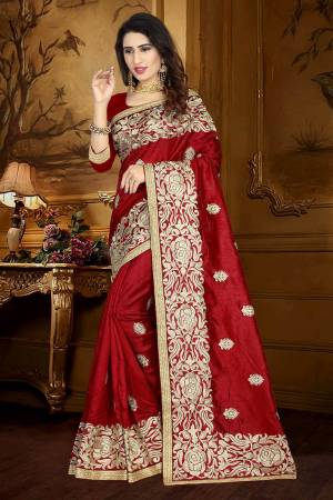 For A Rich And Elegant Look, Grab This Designer Saree In Maroon Color Paired With Maroon Colored Blouse. This Saree And Blouse Are Silk Based Beautified With Resham Embroidery And Lace Border. Buy This Rich Looking Saree Now.