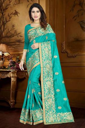 Simple And Elegant looking Designer Saree Is Here In Turquoise Blue Color Paired With Turquoise Blue Colored Blouse. This Saree And Blouse Are Silk Based Beautified With Heavy And Attractive Embroidery. Buy Now.