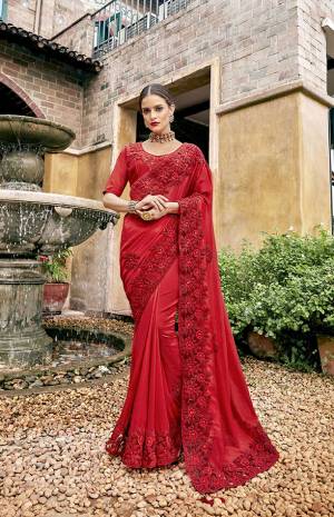 Adorn The Angelic Look In This Pure Red Colored Saree Paired With Red Colored Blouse. This Saree Is Fabricated On Satin Silk Paired With Art Silk Fabricated Blouse. It Is Beautified With Pretty Tone To Tone Embroidery. 