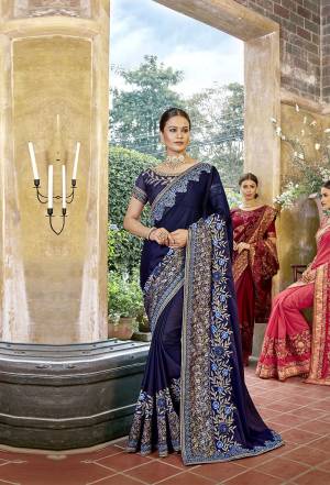 Enhance Your Personality Wearing This Designer Saree In Navy Blue Color Paired With Navy Blue Colored Blouse. This Saree Is Georgette Based Paired With Art Silk Blouse Beautified With Heavy Embroidery. 