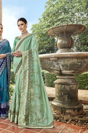 This Season Is About Subtle Shades And Pastel Play, So Grab This Pretty Designer Saree In Pastel Green Color Paired With Pastel Green Colored Blouse. This Saree And Blouse Are Silk Based Beautified With Attractive Embroidery All Over. 