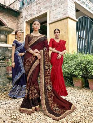 For A Royal Look, Grab This Heavy Designer Saree In Dark Maroon Color Paired With Dark Brown Colored Blouse. This Saree Is Fabricated On Georgette Paired With Art Silk Fabricated Blouse. This Saree Is Easy To Drape And Carry All Day Long. 