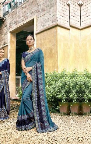 Enhance Your Personality Wearing This Designer Saree In Blue Color Paired With Blue Colored Blouse. This Saree Is Georgette Based Paired With Art Silk Blouse Beautified With Heavy Embroidery. 