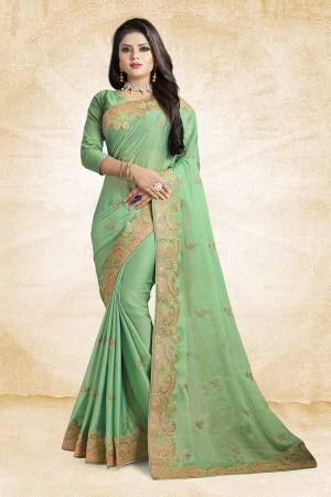Get Ready For The Upcoming Festive And Wedding Season Wearing This Designer Saree In Green Color Paired With Green Colored Blouse. This Saree And Blouse Silk Based Beautified With Elegant Embroidered Lace Border. 