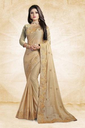 Get Ready For The Upcoming Festive And Wedding Season Wearing This Designer Saree In Beige Color Paired With Beige Colored Blouse. This Saree And Blouse Silk Based Beautified With Elegant Embroidered Lace Border. 