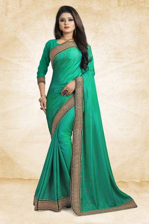 Here Is A Heavy And Elegant Looking Designer Saree In Sea Green Color Paired With Sea Green Colored Blouse. This Saree Is Fabricated On Satin Silk Paired With Art Silk Fabricated Blouse. It Has Heavy Embroidered Lace Border With Stone Work. Buy Now.