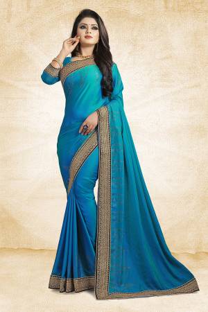 Here Is A Heavy And Elegant Looking Designer Saree In Blue Color Paired With Blue Colored Blouse. This Saree Is Fabricated On Satin Silk Paired With Art Silk Fabricated Blouse. It Has Heavy Embroidered Lace Border With Stone Work. Buy Now.