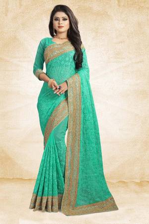 Get Ready For The Upcoming Wedding Season With This Heavy Designer Saree In Sea Green Color Paired With Sea Green Colored Blouse. This Saree Is Fabricated On Chiffon Beautified With Heavy Embroidery And Heavy Embroidered Lace Border Paired With Art Silk Fabricated Blouse. 