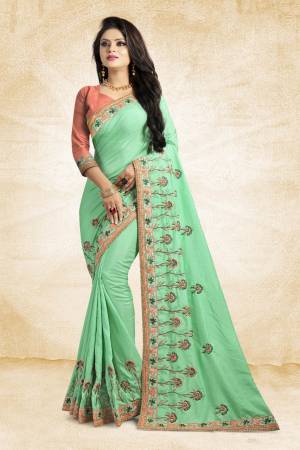 Look Pretty In This Lovely Designer Saree In Light Green Color Paired With Peach Colored Blouse. This Pretty Embroidered Saree In Fabricated On Satin Silk Paired With Art Silk Fabricated Blouse. It Has Contrasting Colored Embroidery Giving The Saree An Attractive Look.