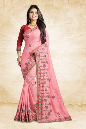Look Pretty In This Lovely Designer Saree In Pink Color Paired With Red Colored Blouse. This Pretty Embroidered Saree In Fabricated On Satin Silk Paired With Art Silk Fabricated Blouse. It Has Contrasting Colored Embroidery Giving The Saree An Attractive Look.