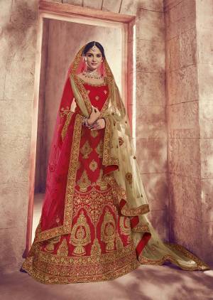 Here Is A Perfect Bridal Look For You With This Heavy designer Lehenga Choli In Red Color. This Lehenga Choli Is Silk Based Paired With Net Fabricated Dupatta Two Dupattas, One In Red And Another In Beige Color. Its Fabric Also Ensures Superb Comfort Throughout The Gala. 