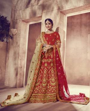 Get Ready For Your Big Day With This Heavy Designer Lehenga Choli In Red Color. This Heavy Embroidered Lehenga Choli Is Fabricated On Art Silk Paired With Net Fabricated Two Dupattas, One In Red And Another In Beige Color. It Is Beautified With Heavy Jari Embroidery and Stone Work. Buy Now