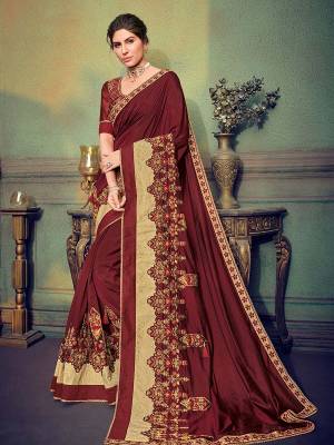 Classy, sensuous and versatile are the perfect words to describe this maroon color two tone silk fabrics saree. Ideal for party, festive & social gatherings. this gorgeous saree featuring a beautiful mix of designs. Its attractive color and designer heavy embroidered saree, stone design, beautiful floral design work over the attire & contrast hemline adds to the look. Comes along with a contrast unstitched blouse.