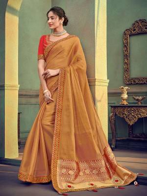 Change your wardrobe and get classier outfits like this gorgeous beige color two tone simmer georgette saree. Ideal for party, festive & social gatherings. this gorgeous saree featuring a beautiful mix of designs. Its attractive color and designer heavy embroidered saree, stone design, beautiful floral design work over the attire & contrast hemline adds to the look. Comes along with a contrast unstitched blouse.