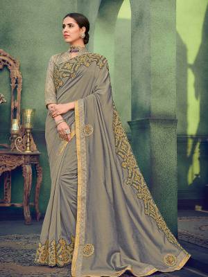 Get this amazing saree from and look pretty like never before. wearing this grey color silk fabrics saree. Ideal for party, festive & social gatherings. this gorgeous saree featuring a beautiful mix of designs. Its attractive color and designer heavy embroidered saree, stone design, beautiful floral design work over the attire & contrast hemline adds to the look. Comes along with a contrast unstitched blouse.