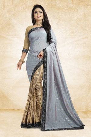 Here Is A Designer Saree In Unique Skirt Pallu Pattern. This Saree Is In Grey And Beige Color Paired With beige Colored Blouse. This Saree Is Fabricated On Jacquard Silk Paired With Art Silk Fabricated Blouse. Its Rich Silk Fabric Earn You Lots Of Compliments From Onlookers. 