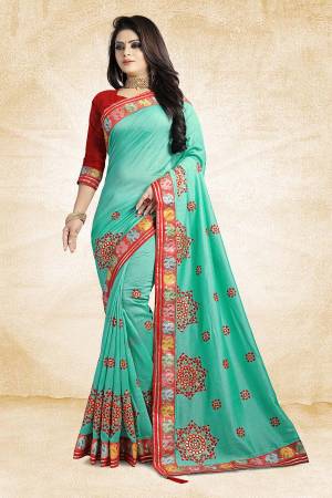 Go Colorful This Festive Season Wearing This Designer Saree In Sea Green Color Paired With Contrasting Red Colored Blouse. This Saree And Blouse Are Silk Based Beautified With Contrasting Work Over It. Buy This Designer Saree Now.