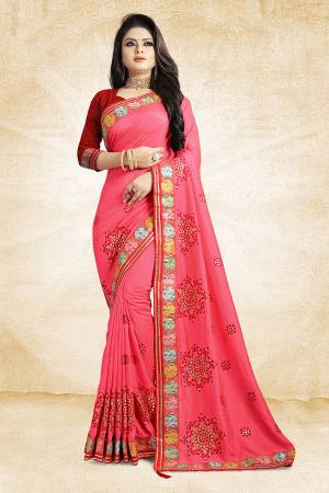 Go Colorful This Festive Season Wearing This Designer Saree In Pink Color Paired With Contrasting Red Colored Blouse. This Saree And Blouse Are Silk Based Beautified With Contrasting Work Over It. Buy This Designer Saree Now.
