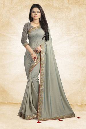 Flaunt Your Rich And Elegant Taste Weairng This Designer Silk Based Saree In Grey Color Paired With Grey Colored Blouse. It Is Beautified With Attractive Embroidered Lace Border.