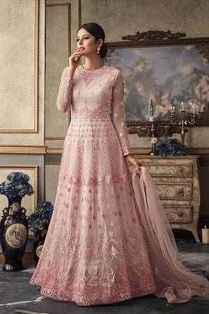 Look The Prettiest Of All Wearing This Heavy Designer Floor Length Suit In Baby Pink Colored Top Paired With Baby Pink Colored Bottom And Dupatta. Its Top Is Fabricated On Net Beautified With Heavy Embroidery Paired With Art Silk  Bottom And Net Dupatta. Buy Now.