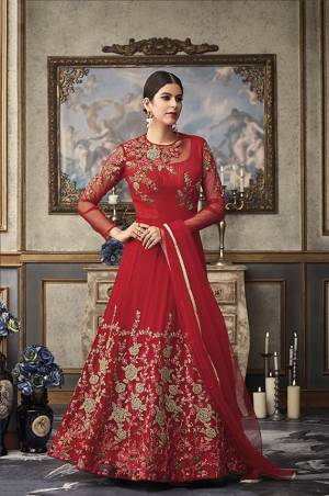 Adorn The Pretty Angelic Wearing This Heavy Designer Floor Length Suit In Red Color Paired With Red Colored Bottom And Dupatta. Its Top And Dupatta Are Fabricated On Net Beautified With Heavy Embroidery Paired With Art Silk Fabricated Bottom .