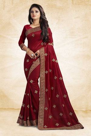 Look Pretty In This Lovely Designer Saree In Maroon Color Paired With Maroon Colored Blouse. This Pretty Embroidered Saree In Fabricated On Vichitra Silk Paired With Art Silk Fabricated Blouse. It Has Jari Embroidery With Stone Work Giving The Saree An Attractive Look.