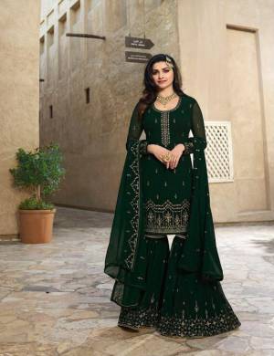 Grab This Designer Sharara Suit For The Upcoming Festive Season. This Pretty All Over Suit Is In Dark Green Color. Its Top And Bottom Are Georgette Based Beautified Wih Attactive Embroidery Paired With Chiffon Fabricated Dupatta. Buy Now.
