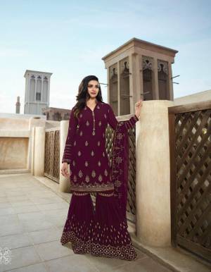 Here Is A Very Pretty Designer Sharara Suit In Wine Color Paired With Wine Colored Bottom And Dupatta. Its Top And Bottom Are Fabricated On Georgette paired With Chiffon Fabricated Dupatta. Buy Now.