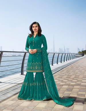 Add This Beautiful designer Suit To Your Wardrobe In Turquoise Blue Color Paired With Turquoise Blue Colored Bottom And Dupatta. Its Top Is Fabricated On Georgette Paired With Georgette Fabricated Sharara And Chiffon Dupatta. This Suit Is Light Weight And Easy To Carry Throughout The Gala. 
