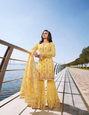 Celebrate This Festive Season With Ease And Comfort Wearing This Heavy Designer Sharara Suit In Yellow Color Paired With Yellow Colored Bottom And Dupatta. This Suit Is Georgette Based Paired With Chiffon Fabricated Dupatta. All Its Fabrics Are Light Weight And Easy To Carry All Day Long. 
