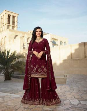 Grab This Designer Sharara Suit For The Upcoming Festive Season. This Pretty All Over Suit Is In Maroon Color. Its Top And Bottom Are Georgette Based Beautified Wih Attactive Embroidery Paired With Chiffon Fabricated Dupatta. Buy Now.