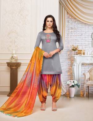 Rich And Elegant Looking Patiala Suit In Grey Colored Top Paired With Multi Colored Bottom And Dupatta. This Dress Material Is Fabricated On Soft Silk Beautified With Hand Work Over The Top. Buy Now.