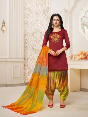 For A Royal Attractive Look, Grab This Designer Patiala Suit In Maroon Colored Top Paired With Contrasting Multi Colored Bottom And Dupatta. This Dress Material Is Fabricated On Soft Silk Beautified With Hand Work Over The Top. It IS Light Weight And Easy To Carry All Day Long. 