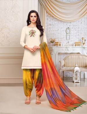 For A Royal Attractive Look, Grab This Designer Patiala Suit In Cream Colored Top Paired With Contrasting Multi Colored Bottom And Dupatta. This Dress Material Is Fabricated On Soft Silk Beautified With Hand Work Over The Top. It IS Light Weight And Easy To Carry All Day Long. 