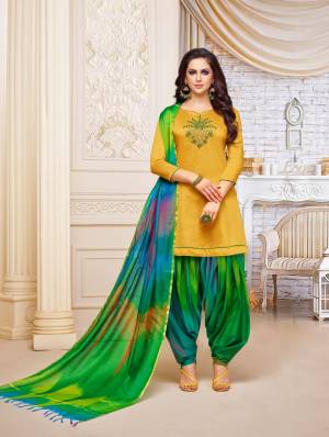 Enhance Your Personality Wearing This Designer Patiala Suit In Musturd Yellow Colored Top Paired With Green Colored Bottom And Dupatta. This Dress Material Is Fabricated On Soft Silk, Get This Stitched As Per Your Desired Fit And Comfort. 