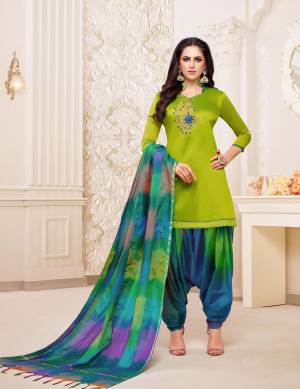 Rich And Elegant Looking Patiala Suit In Parrot Green Colored Top Paired With Blue Colored Bottom And Dupatta. This Dress Material Is Fabricated On Soft Silk Beautified With Hand Work Over The Top. Buy Now.