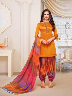 For A Royal Attractive Look, Grab This Designer Patiala Suit In Orange Colored Top Paired With Contrasting Multi Colored Bottom And Dupatta. This Dress Material Is Fabricated On Soft Silk Beautified With Hand Work Over The Top. It IS Light Weight And Easy To Carry All Day Long. 