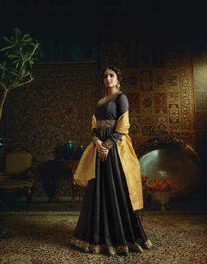 For A Bold And Beautiful Look, Grab This Designer Floor Length Suit In Black Color Paired With Contrasting Yellow Colored Dupatta. Its Top Is Fabricated On Satin Georgette Paired With Santoon Bottom And Banarasi Jacquard Silk Dupatta. Its Rich Color Combination And Elegant Emboidery Will Earn You Lots Of Compliments From Onlookers. 