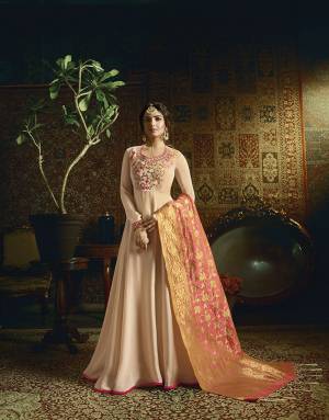 Look Pretty In This Designer Floor Length Suit In Peach Color Paired With Contrasting Pink Colored Dupatta. Its Top Is Fabricated On Rich Satin Georgette Fabric Paired With Santoon Bottom And Banarasi Jacquard Silk Dupatta. 