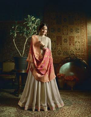 Flaunt Your Rich And Elegant Taste Wearing This Designer Floor Length Suit In Pale Grey Color Paired With Contrasting Dark Pink Colored Dupatta. Its Top Is Fabricated On Satin Georgette Paired With Santoon Bottom And Banarasi Jacquard Silk Dupatta. Buy Now.