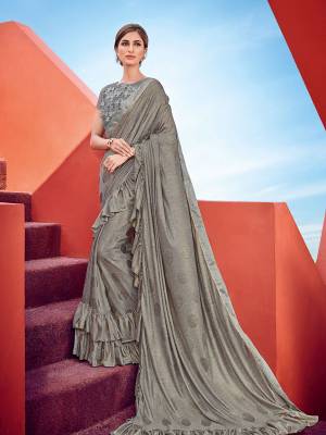 Wear this grey color inported fabrics with ruffled/ frill border saree. this party wear saree won't fail to impress everyone around you. this gorgeous saree featuring a beautiful mix of designs. Its attractive color and designer imported heavy embroidered design, party wear ruffled/ frill saree Patterns, beautiful floral design work over the attire & contrast hemline adds to the look. Comes along with a contrast unstitched blouse.