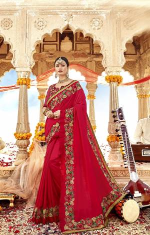 Adorn The Pretty Angelic Look wearing This Designer Saree In Red Color Paired With Red Colored Blouse. This Saree Is Fabricated On Soft Silk Paired With Art Silk And Net Fabricated Blouse. It Is Beautified With Heavy Embroidery Over The Saree And Blouse. 
