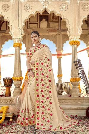 Simple And Elegant Looking Designer Saree Is Here In Rich Cream Color Paired With Cream Colored Blouse. This Saree Is Fabricated On Soft Silk Paired With Art Silk And Net Fabricated Blouse. It Has Pretty Contrasting Embroidery giving It An Attractive Look .