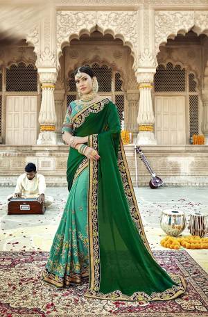 Go With The Shades Of Green Wearing This Designer Saree In Dark Green And Sea Green Color Paired With Sea Green Colored Blouse. This Saree Is Fabricated On Satin Silk paired With Art Silk And Net Fabricated Blouse. 