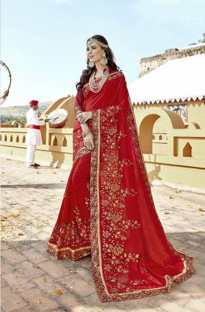 Adorn the Pretty Angelic Look Wearing This Designer Saree In Red Color Paired With Red Colored Blouse. This Saree And Blouse Are Silk Based Beautified With Heavy Work. 
